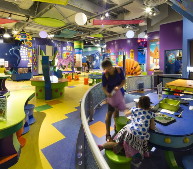 Children and adults enjoying the games at the Discovery Children's Museum, designed by LGA Architecture.