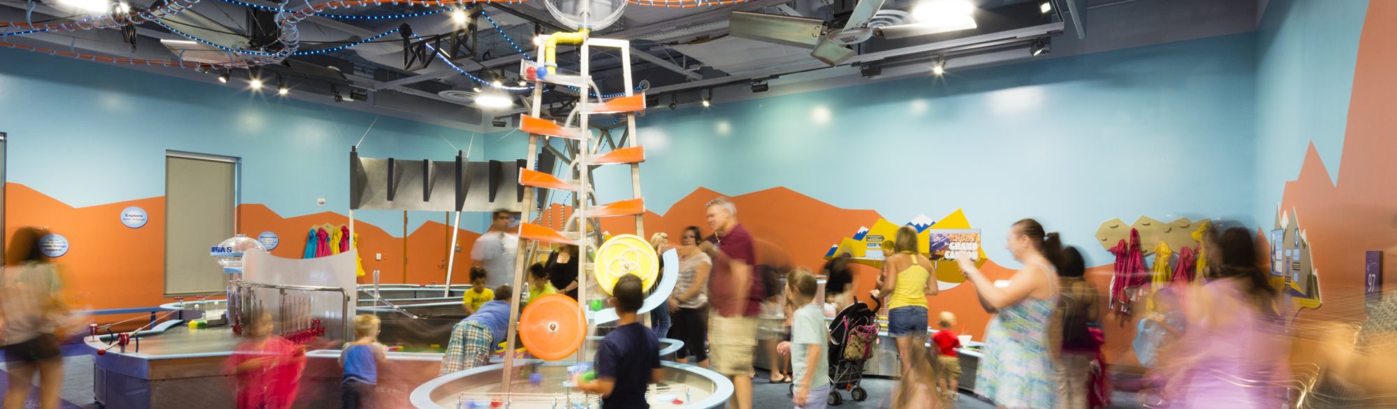 Children and adults enjoying the exhibits at the Discovery Children's Museum, designed by LGA Architecture.