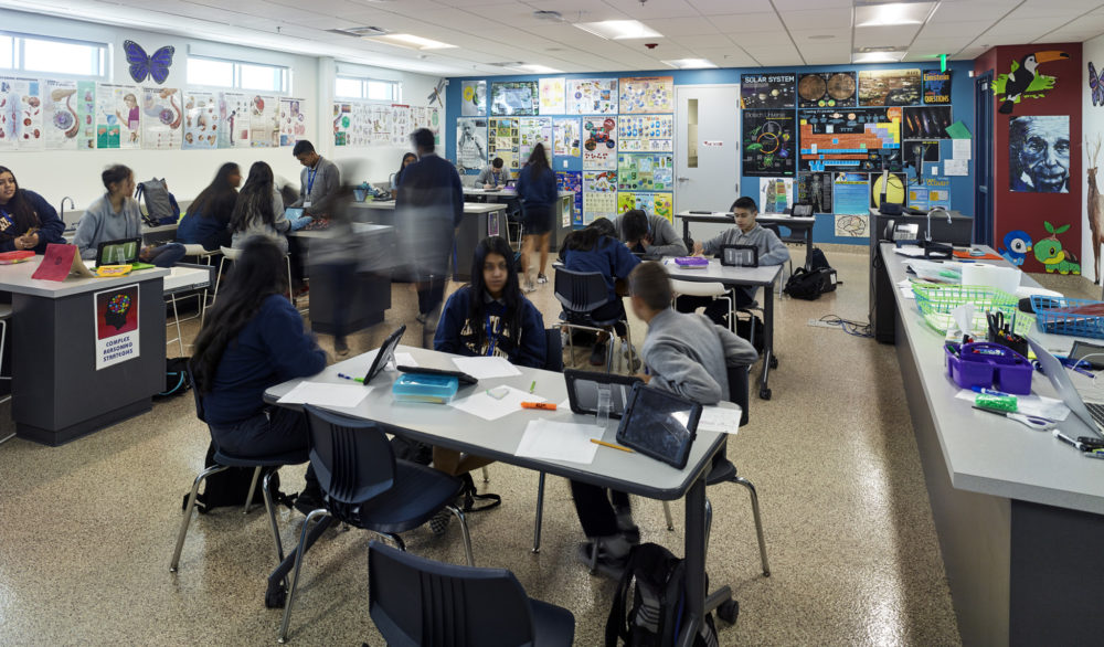 Children studying in a classroom at the Cristo Rey St. Viator College Preparatory Academy, education design by LGA Architecture.